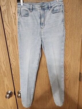 American Eagle light wash denim jeans with tan stitching